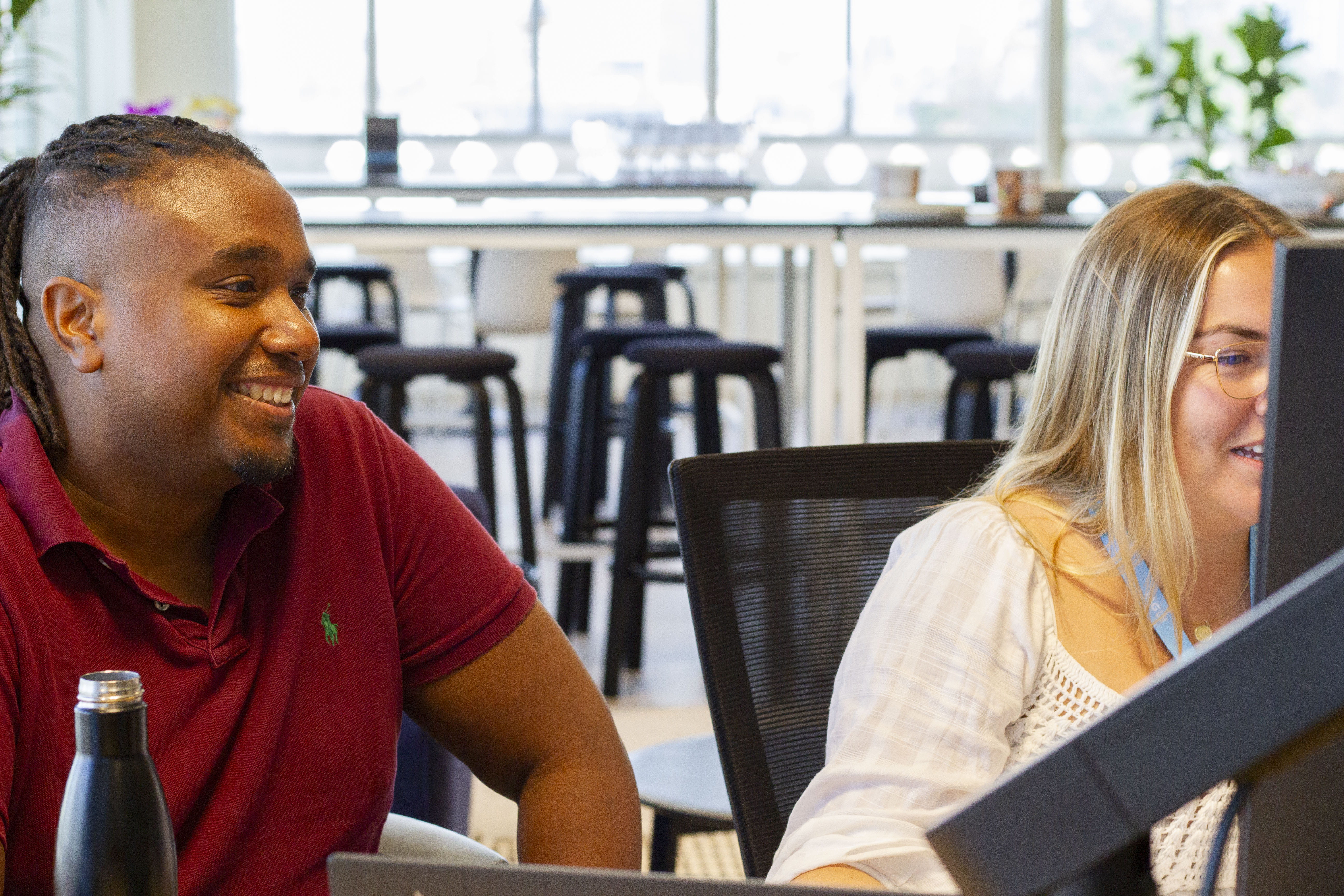 Colleagues working around computer