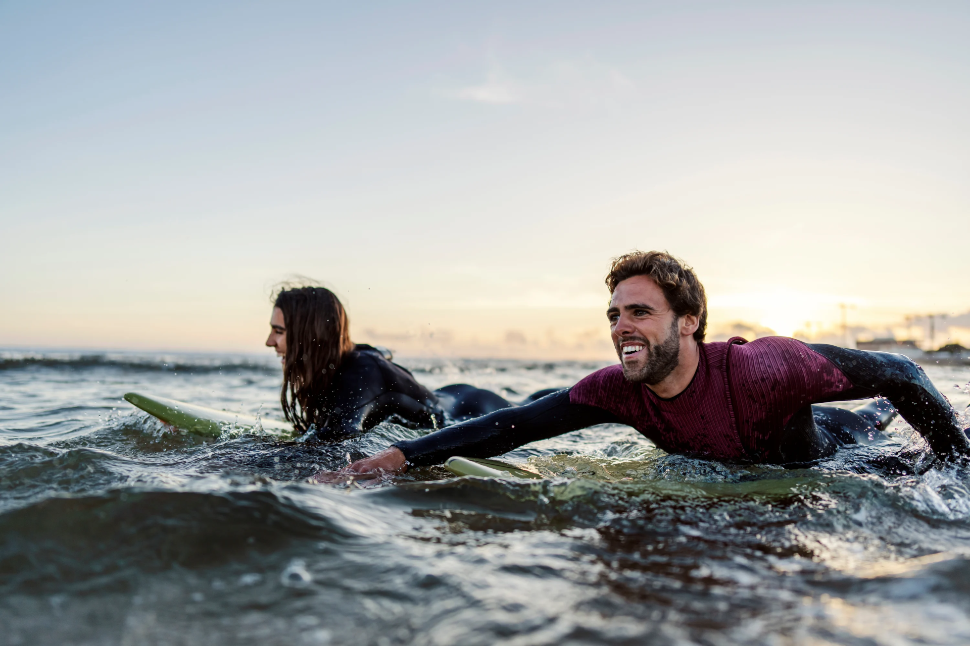 Man and woman on paddleboards in sea